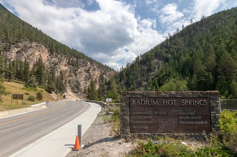 Radium Hot Springs entrance sign and road through Sinclair Canyon in British Columbia