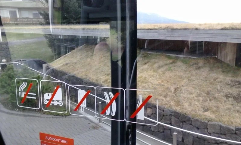 Entrance glazing and visitor-rule signs at Laugarvatn Fontana spa