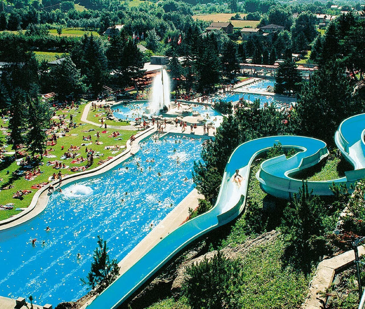 Outdoor thermal pool complex and water slide at Brigerbad Thermal Baths (archive photograph)